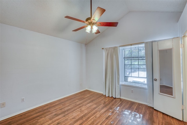 spare room featuring hardwood / wood-style floors, a textured ceiling, high vaulted ceiling, and ceiling fan