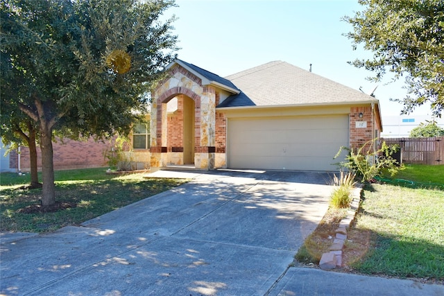 view of front of house featuring a front lawn and a garage