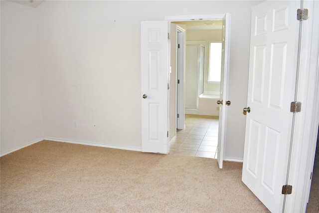 unfurnished room featuring light colored carpet