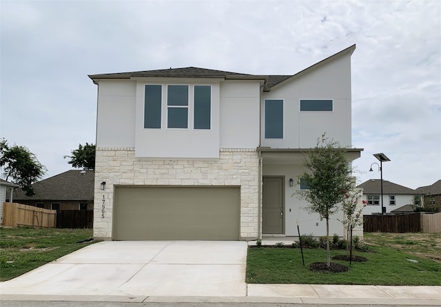 view of front of house featuring a front lawn and a garage