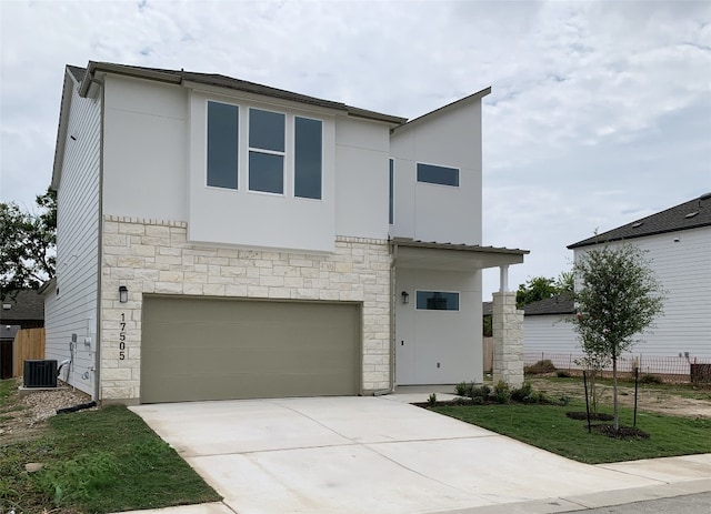 view of front of home with central AC unit and a garage