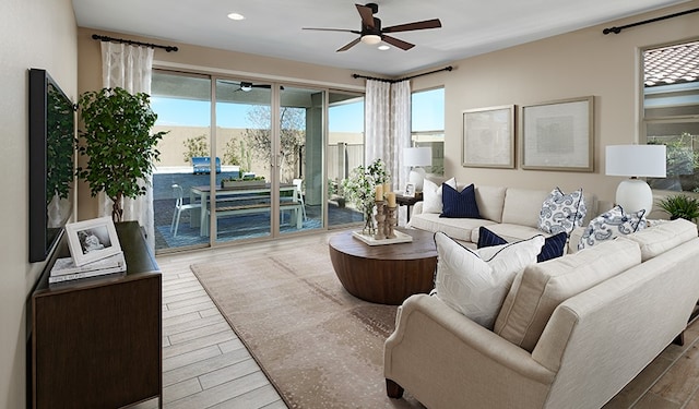 living room with ceiling fan and hardwood / wood-style flooring