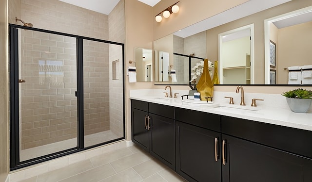 bathroom with tile patterned flooring, vanity, and a shower with shower door