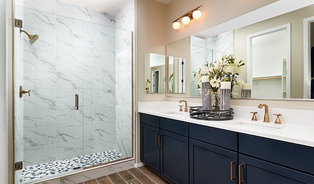 bathroom featuring vanity and an enclosed shower