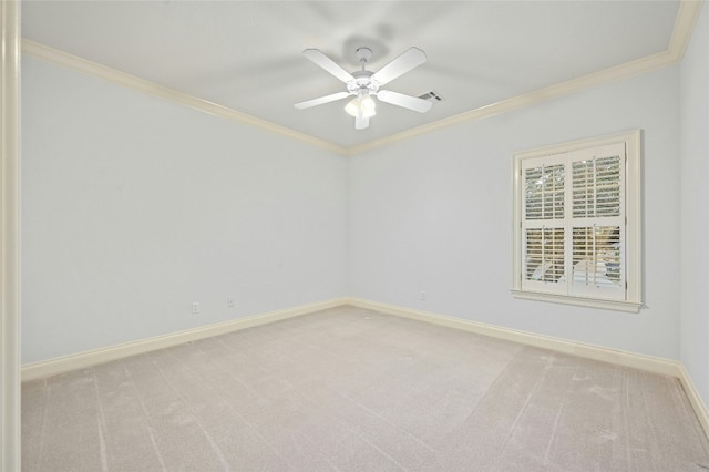 carpeted empty room featuring ceiling fan and ornamental molding