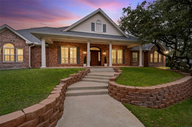 view of front of house featuring a lawn and covered porch