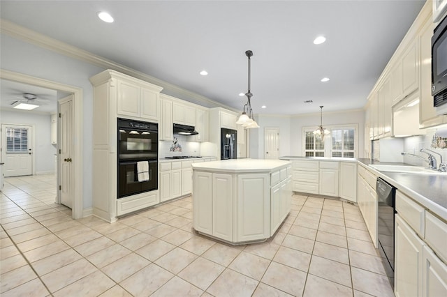 kitchen with sink, a kitchen island, decorative light fixtures, light tile patterned floors, and black appliances