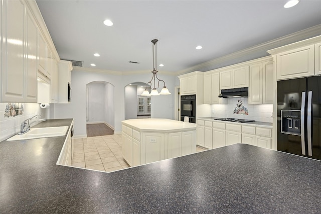 kitchen with backsplash, black appliances, sink, ornamental molding, and decorative light fixtures