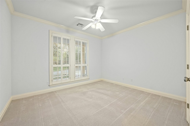 empty room with ceiling fan, light colored carpet, and ornamental molding