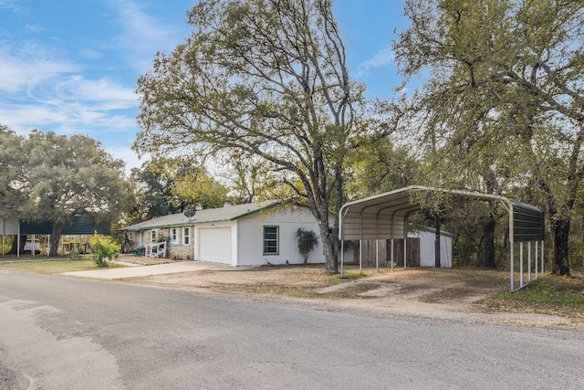 view of front of property featuring a garage and a carport