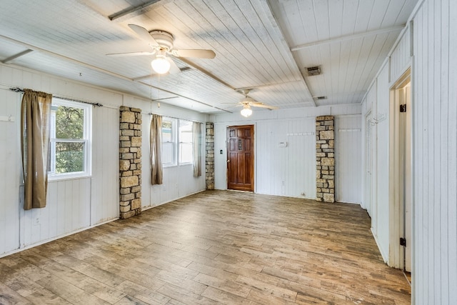 unfurnished room with ceiling fan, wood walls, wooden ceiling, and light hardwood / wood-style flooring