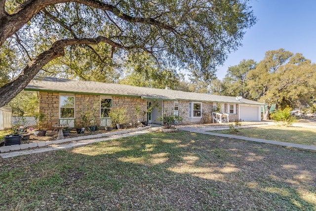 single story home featuring a front lawn and a garage