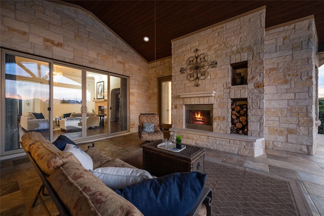 living room featuring high vaulted ceiling, an outdoor stone fireplace, and wooden ceiling