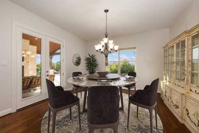 dining room featuring french doors, dark hardwood / wood-style floors, and a notable chandelier