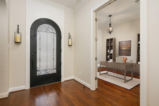 entrance foyer with dark hardwood / wood-style floors and crown molding