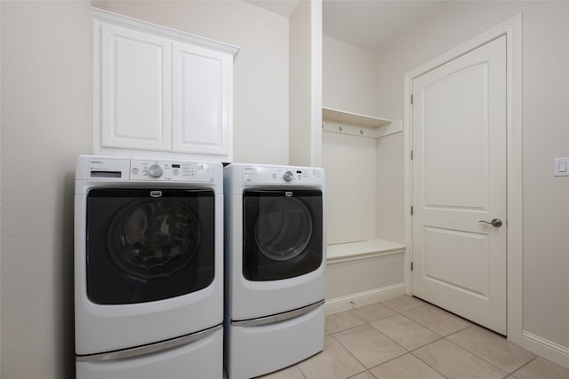 laundry area featuring light tile patterned floors and washer and clothes dryer