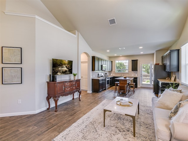 living room with hardwood / wood-style flooring and vaulted ceiling