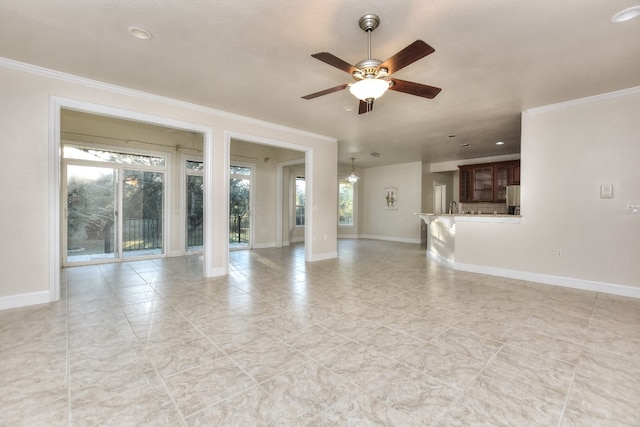 unfurnished living room with ceiling fan and ornamental molding