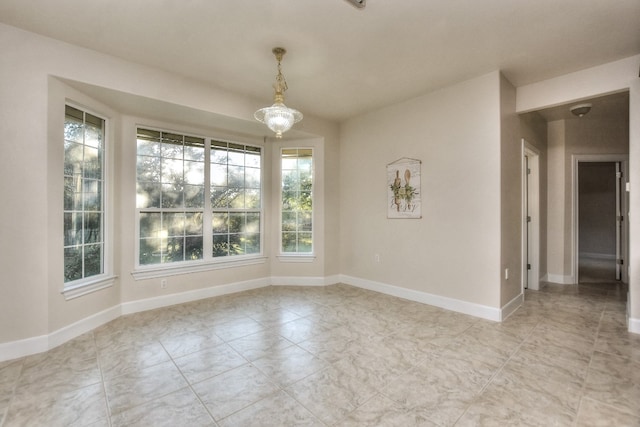 empty room featuring a chandelier