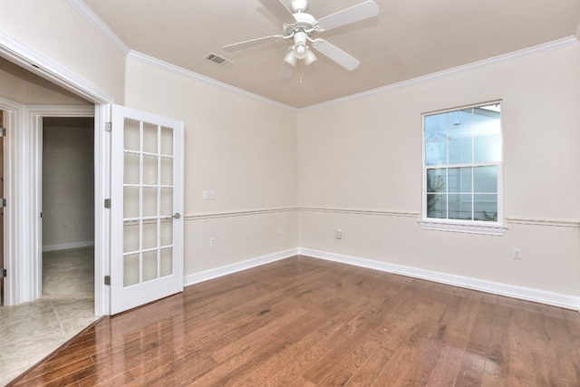 empty room featuring hardwood / wood-style floors, ceiling fan, and ornamental molding