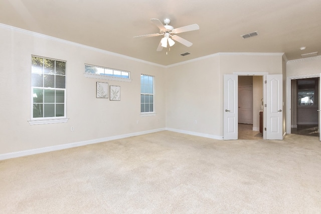 carpeted empty room with ceiling fan and ornamental molding