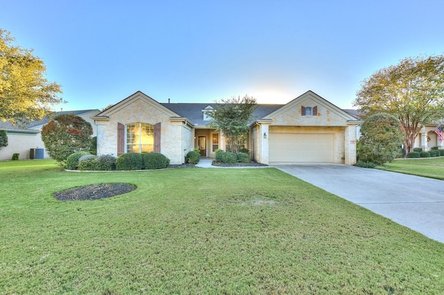 ranch-style house featuring a garage, central AC, and a front lawn