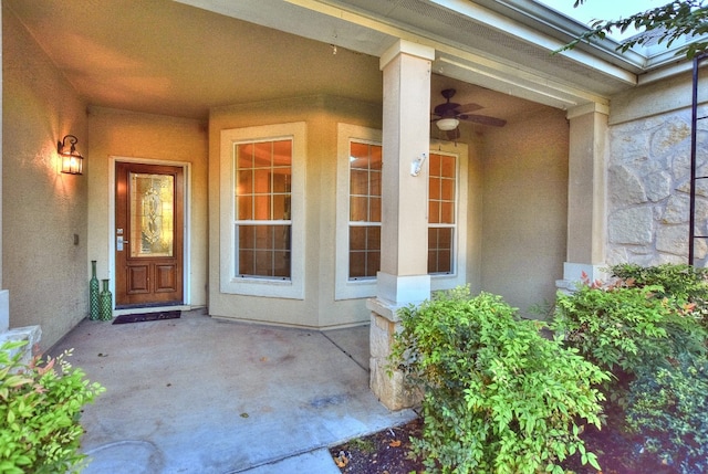 view of exterior entry featuring ceiling fan