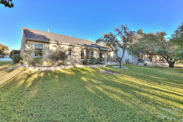 rear view of house with a yard