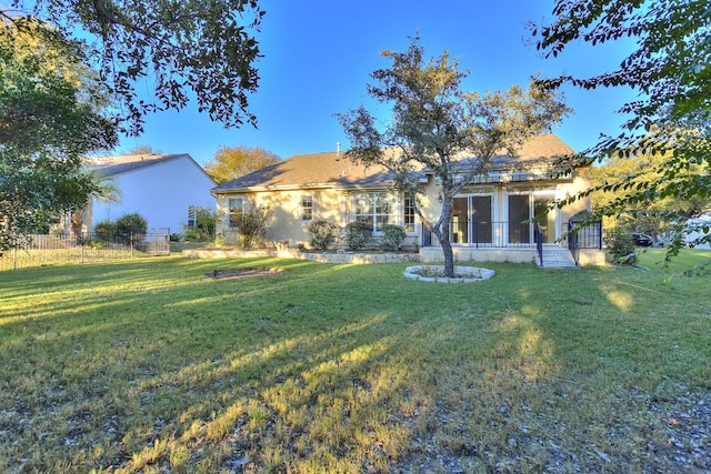 back of house with a lawn