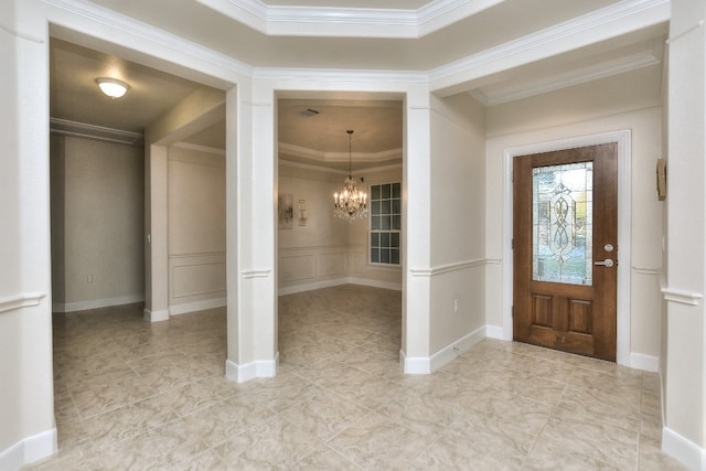 entryway with a chandelier and crown molding