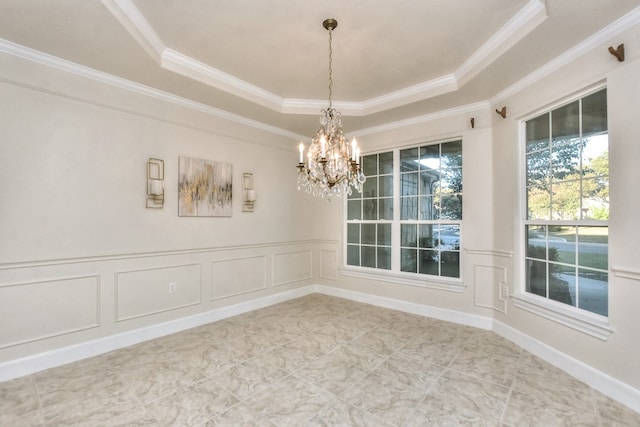 interior space featuring a chandelier, a raised ceiling, and crown molding