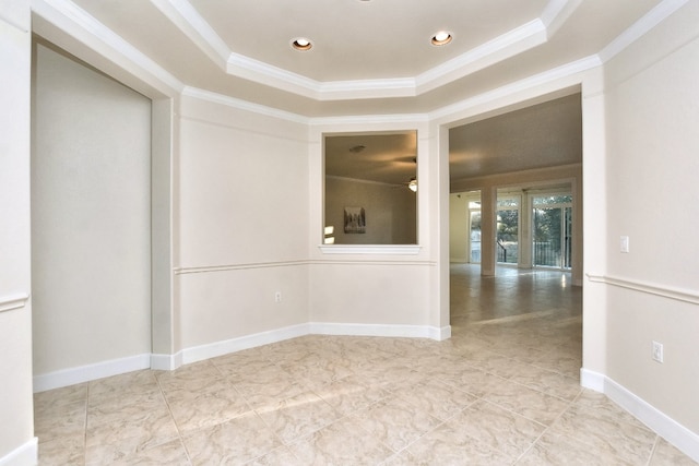 unfurnished room featuring a tray ceiling, ceiling fan, and ornamental molding