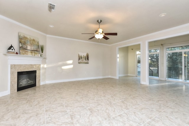 unfurnished living room featuring ceiling fan, ornamental molding, and a tiled fireplace