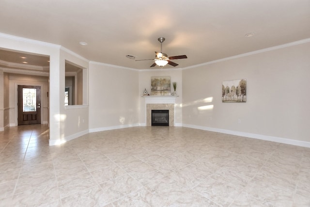 unfurnished living room featuring ceiling fan, crown molding, and a tile fireplace