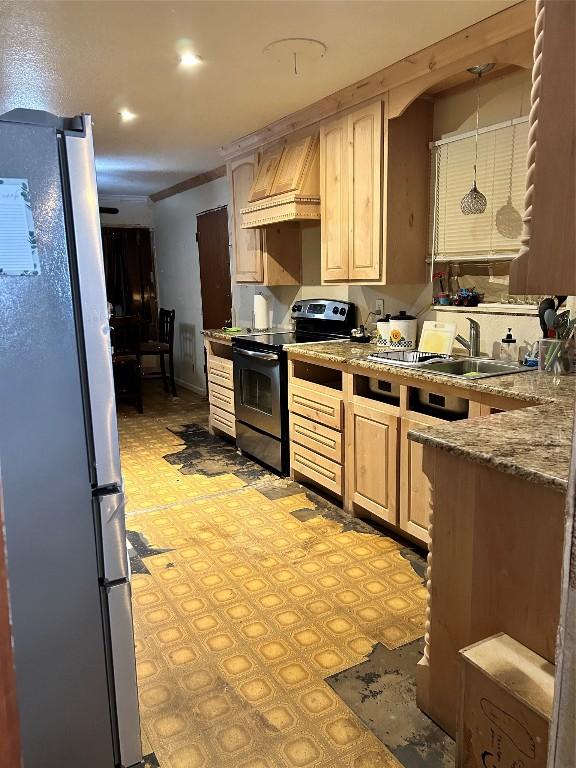 kitchen featuring pendant lighting, custom exhaust hood, light brown cabinets, refrigerator, and electric range