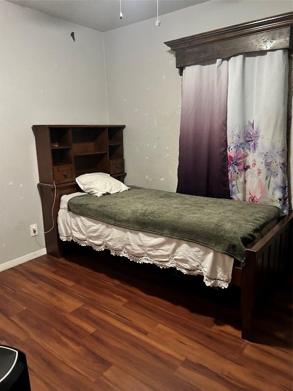 bedroom featuring dark hardwood / wood-style flooring