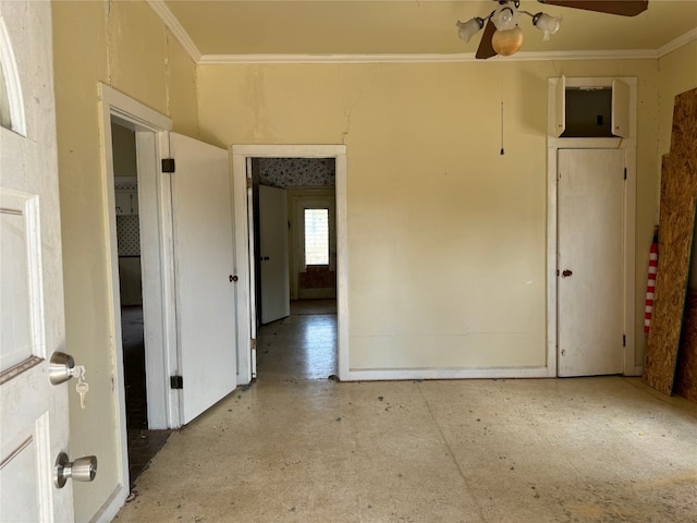 empty room with ceiling fan and crown molding