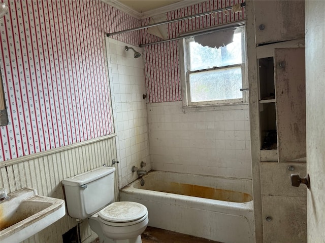 full bathroom featuring sink, tiled shower / bath, ornamental molding, and toilet