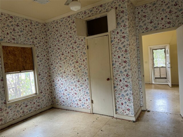 198 Anderson Ln, Red Rock, TX 78662 - unfurnished bedroom featuring crown molding, wallpapered walls, and baseboards