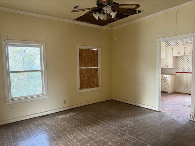 unfurnished room with ceiling fan and ornamental molding