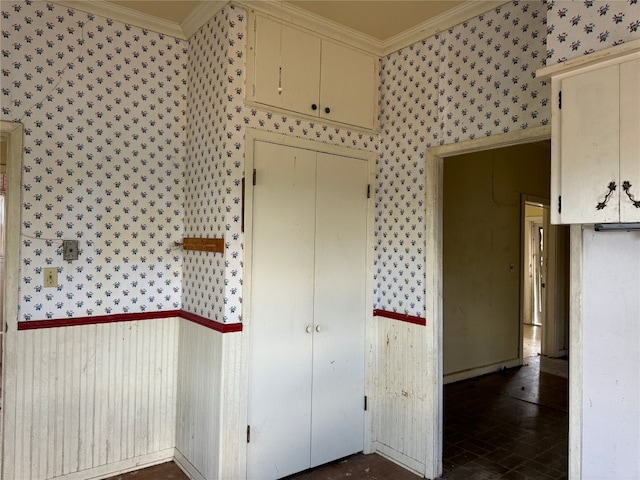 interior space with a closet and crown molding