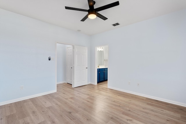 unfurnished bedroom with connected bathroom, light hardwood / wood-style flooring, and ceiling fan