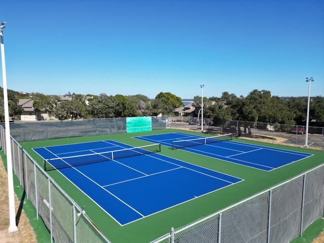 view of tennis court featuring basketball hoop