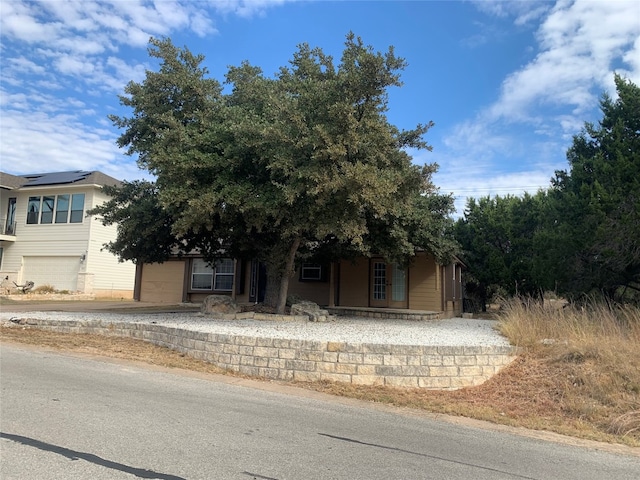 obstructed view of property with a garage