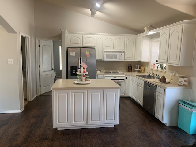 kitchen with a center island, lofted ceiling, sink, appliances with stainless steel finishes, and white cabinetry