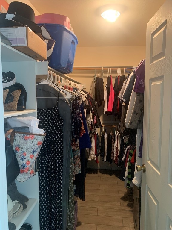 walk in closet with wood-type flooring