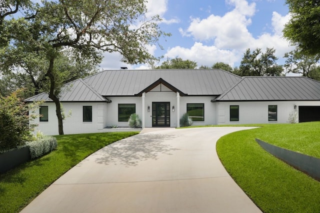4101 Mcbrine Pl, Austin, TX 78746 - modern farmhouse style home featuring a standing seam roof, a front yard, brick siding, and concrete driveway