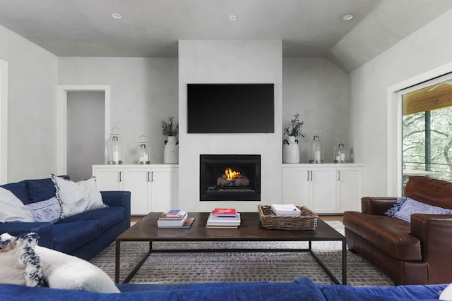 living room featuring lofted ceiling