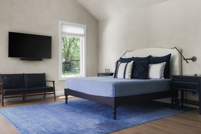 bedroom featuring hardwood / wood-style floors and vaulted ceiling