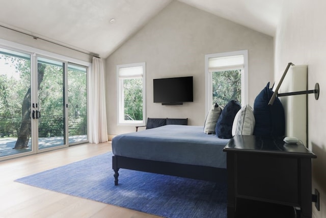 bedroom with access to exterior, high vaulted ceiling, and wood-type flooring